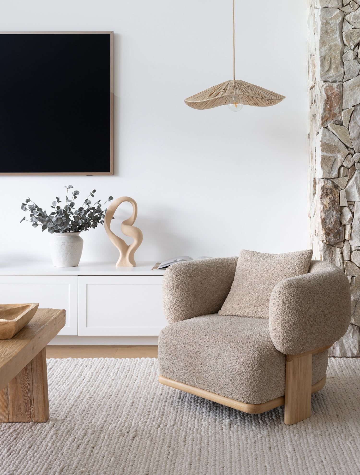 seagrass pendant light shade over a stylish boulce arm chair