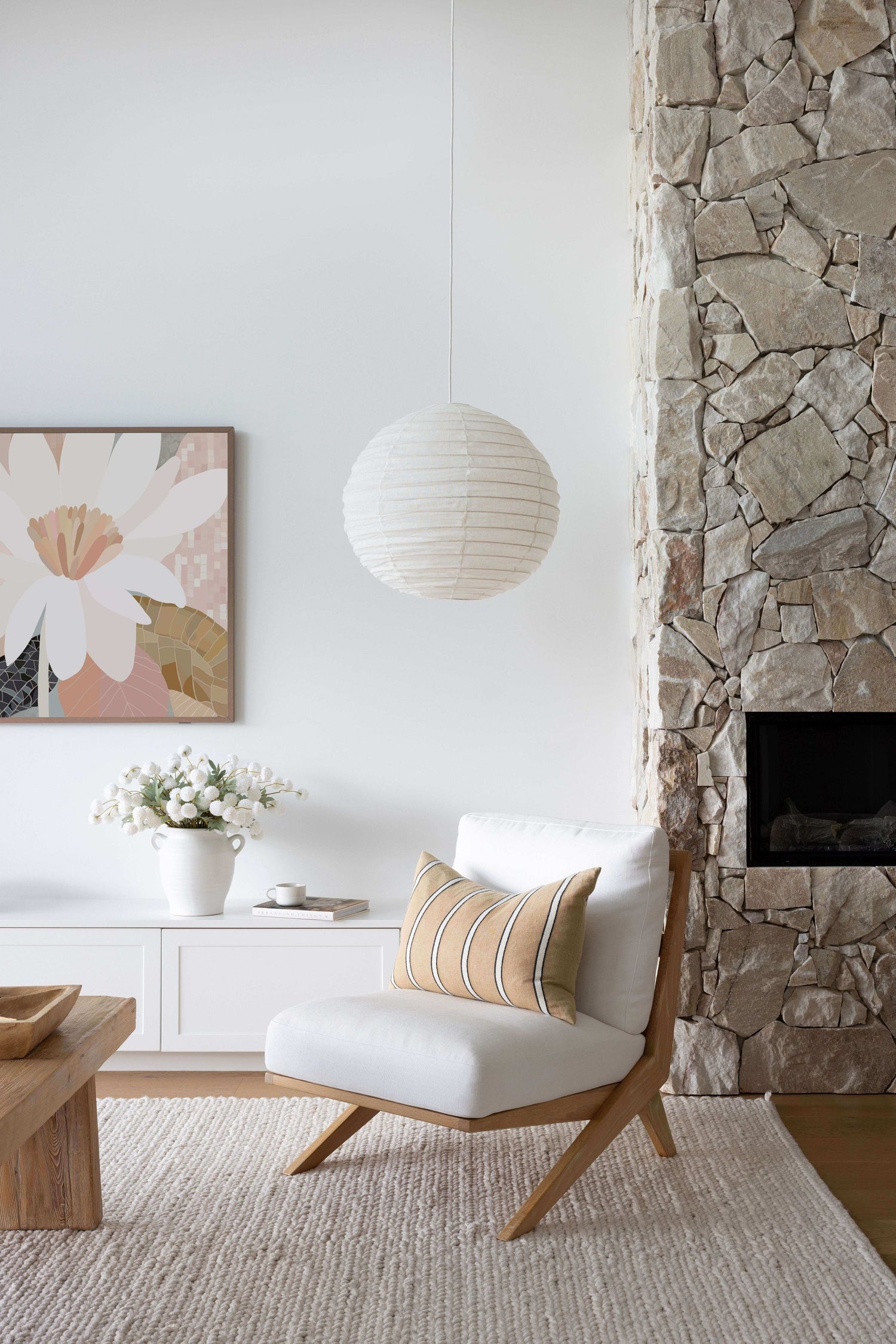 seagrass pendant light shade over a stylish boulce arm chair