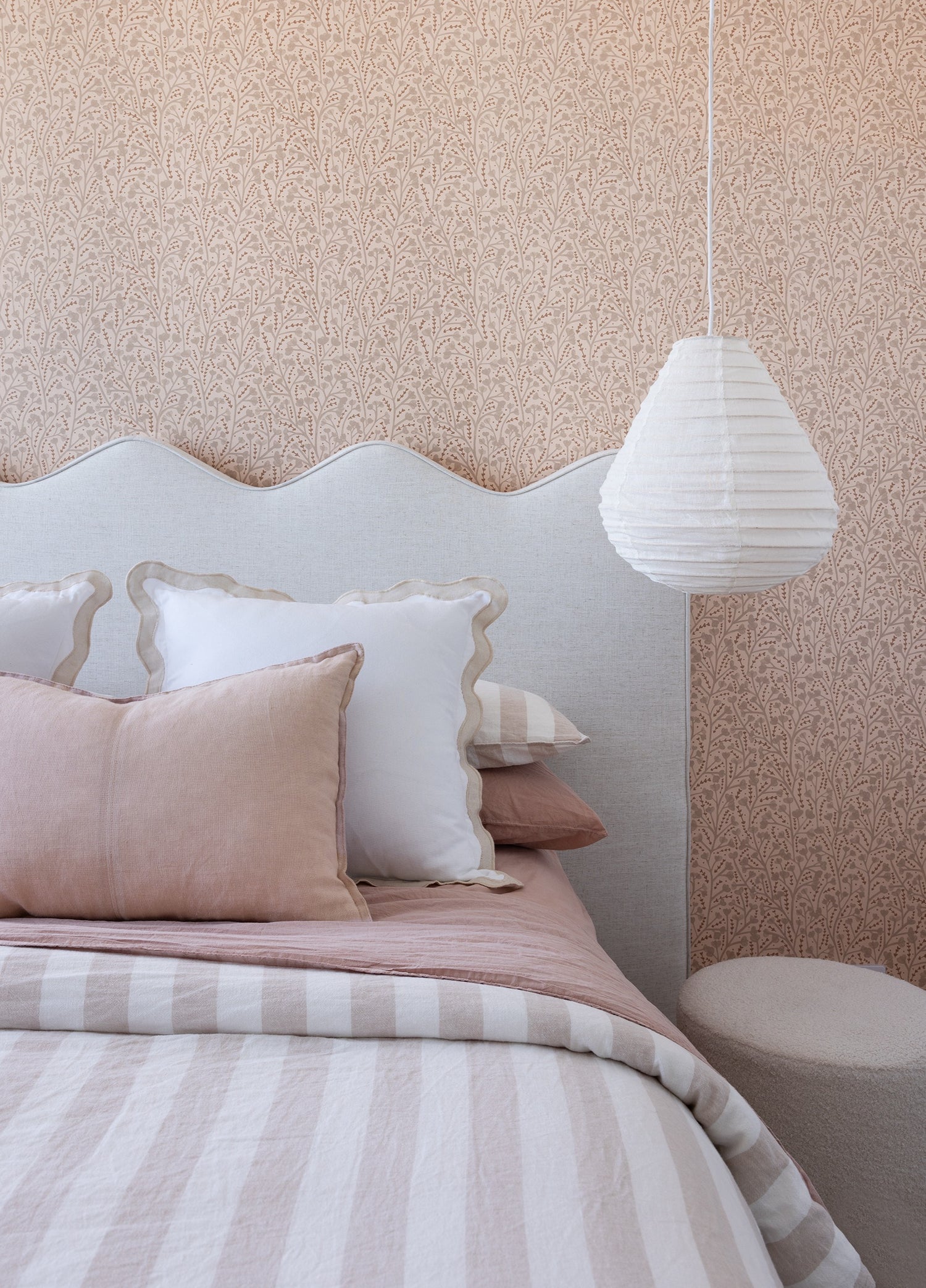 linen light shade used as a bedside light in a dusty pink and beige bedroom