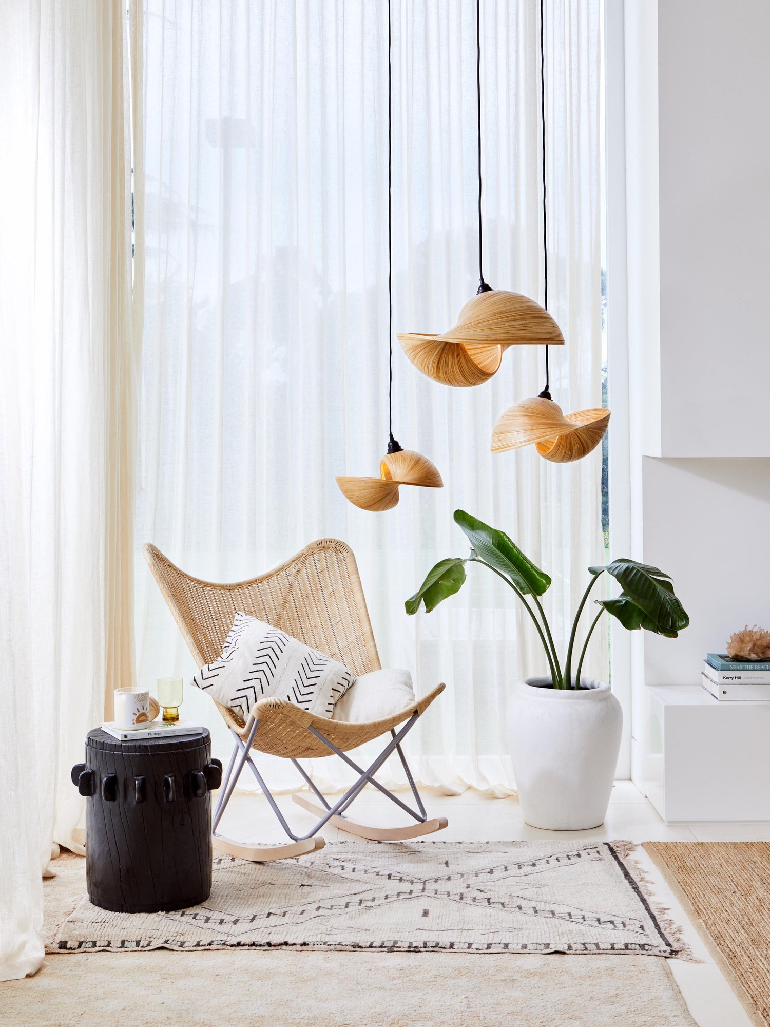 Three Esperance natural pendant lights hang over a coastal rocking chair.