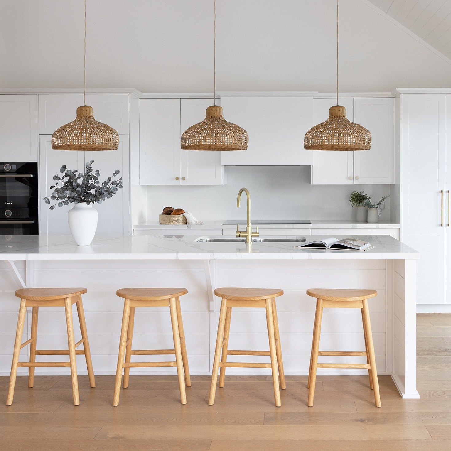 kitchen-pendant-light-in-a-coastal-home-with-white-cabinetry-and-oak-floors-kitchen-lighting-inspiration