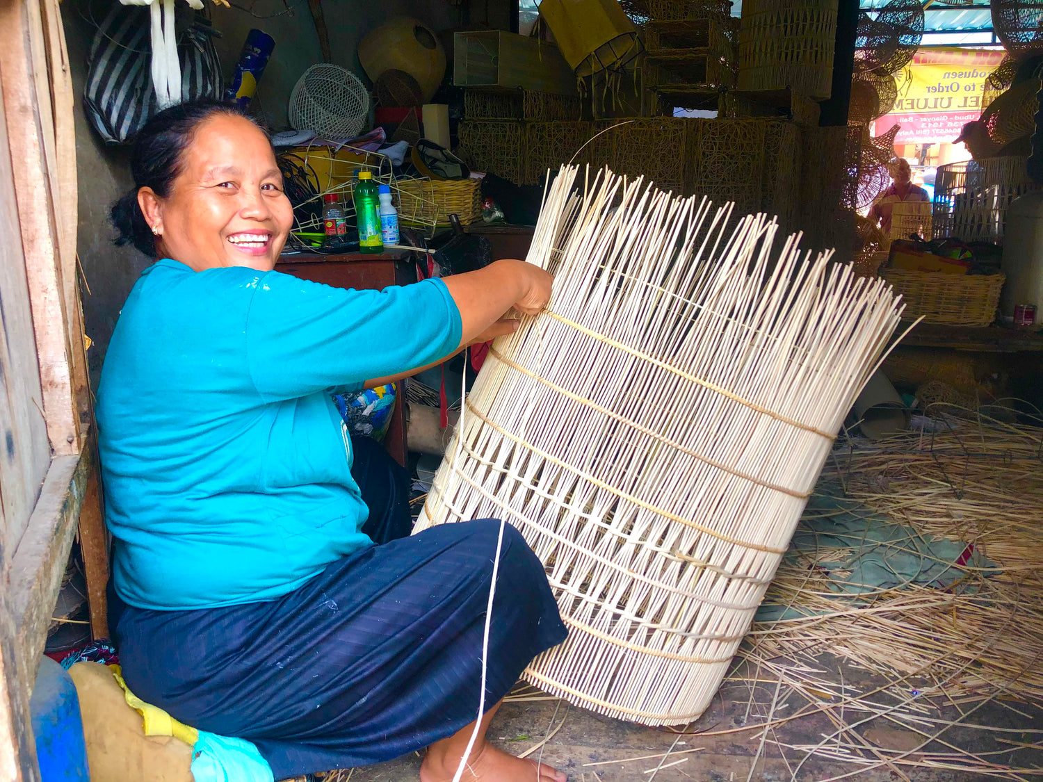 An artisan making rattan pendant feature lights.