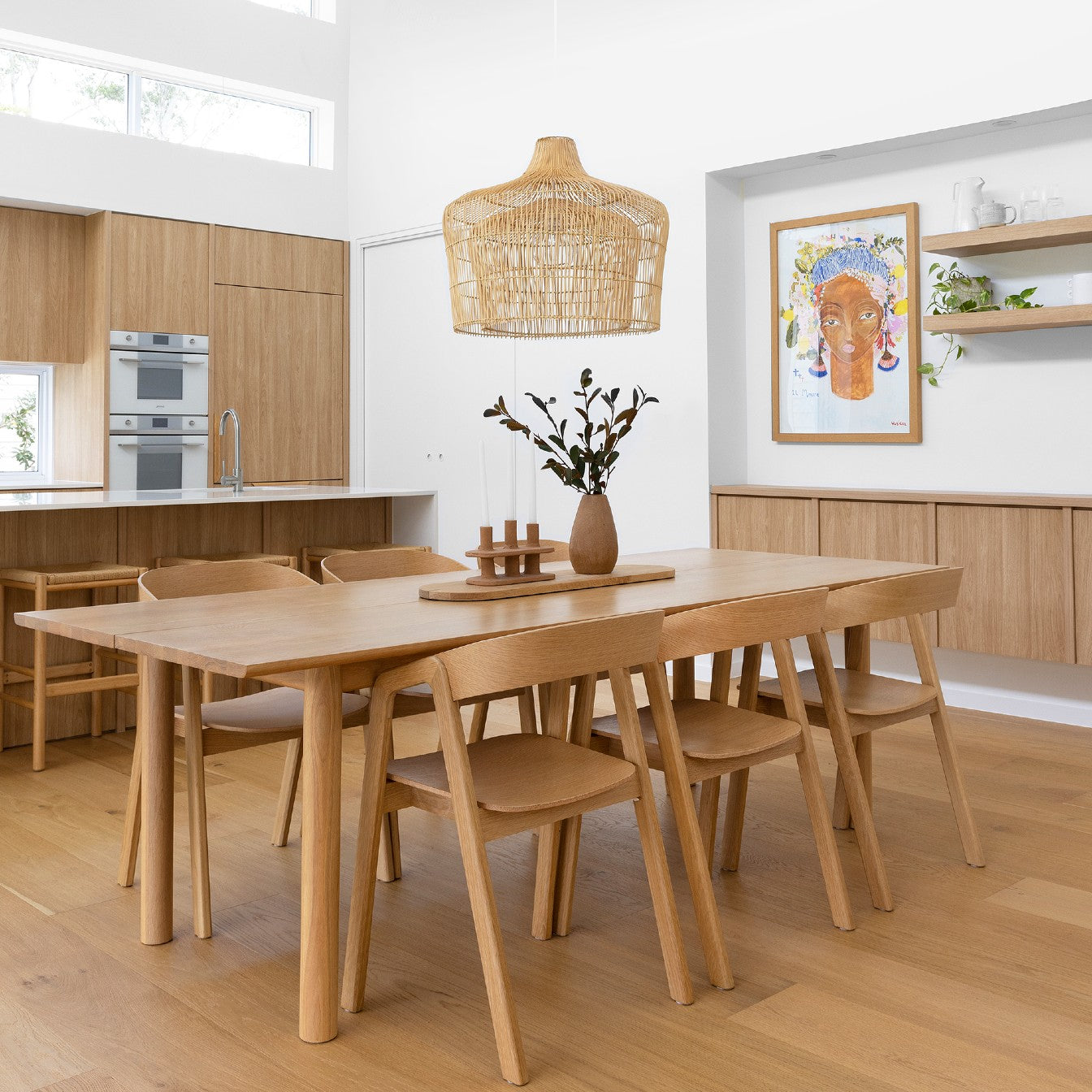 Rattan Pendant Light Australia. Large double caged rattan pendant light over oak dining table in dining room filled with natural light.