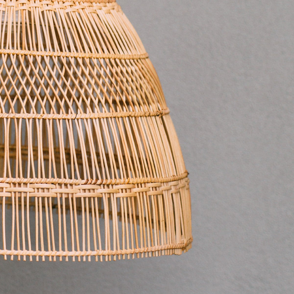 Rattan pendant light. Close-up-photo-of-coastal-style-lighting-natural-rattan-pendant-light-with-straight-and-diamond-weave-design