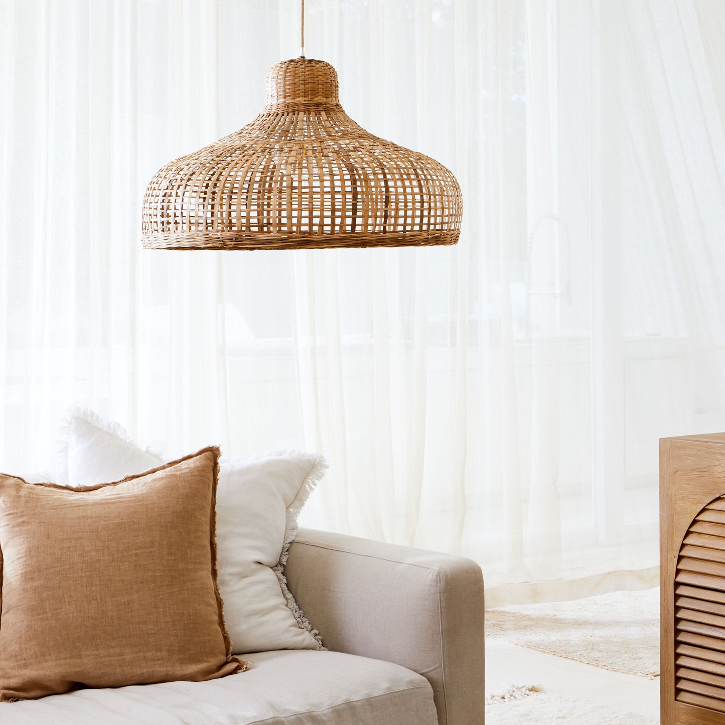 Bamboo pendant light. lifestyle-photo-of-Coastal-hamptons-style-open-weave-bamboo-pendant-light-shade-above-a neutral-coloured-couch-and-cream-and-mustard-coloured-cushions