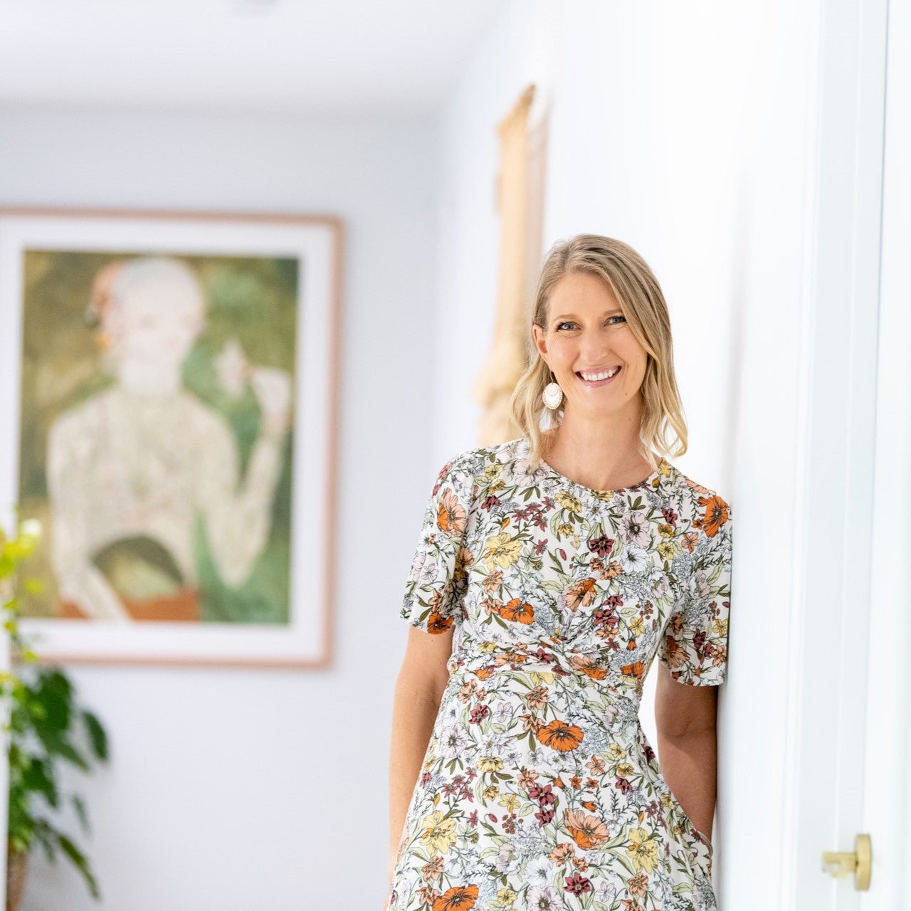 Anna, founder of Lighthouse Lane, the online store for best pendant lights. Anna is smiling directly at the camera and wears a floral summer dress.