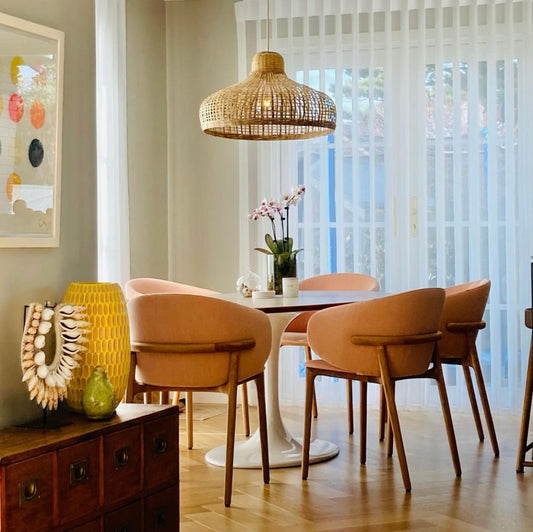 A Portsea focal dining room pendant hangs over a circular dining table.