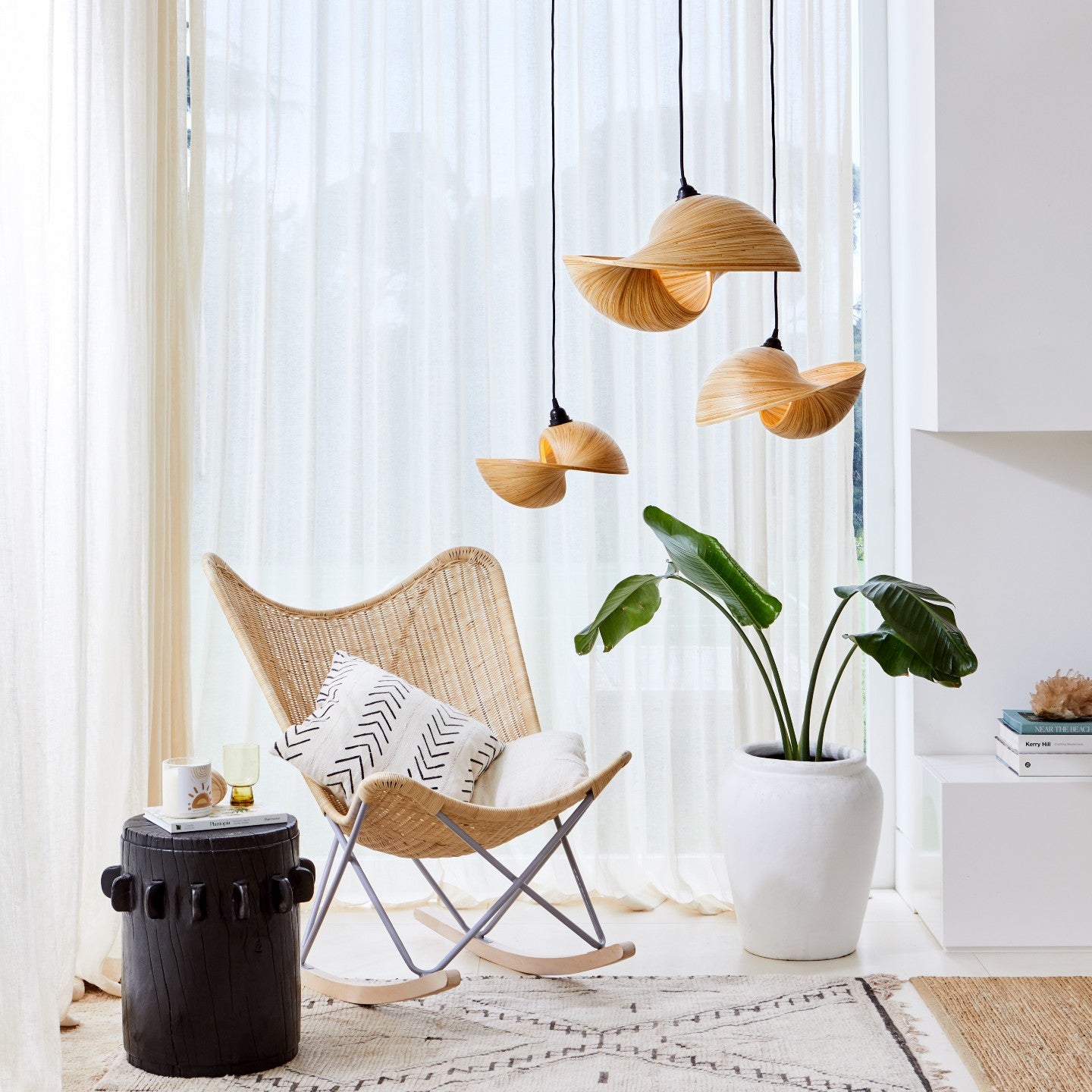three-bamboo-pendant-light-shades-with-wicker-rocking-chair-and-sheer-curtains-in-stylish-living-room