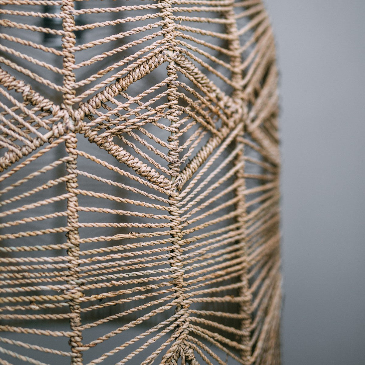 hand woven seagrass pendant light photo shows fine detail of the seagrass wrapped around a frame, diamond pattern looks divine.