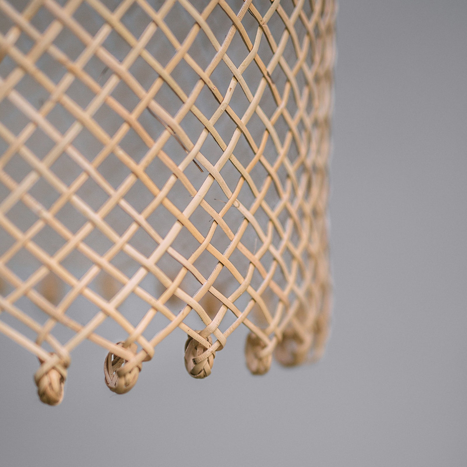 Natural-coastal-style-lighting-photo-showing-detail-of-a-borneo-basket-light-shade-with-open-weave-and-ring-detail-at-the-bottom