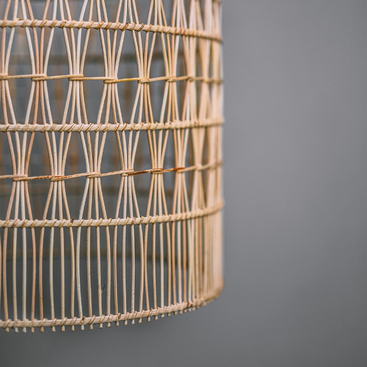 close-up-of-coastal-style-lighting-showing-detail-in-woven-rattan-light-shade-cylindrical. Mediterranean style rattan light shade.