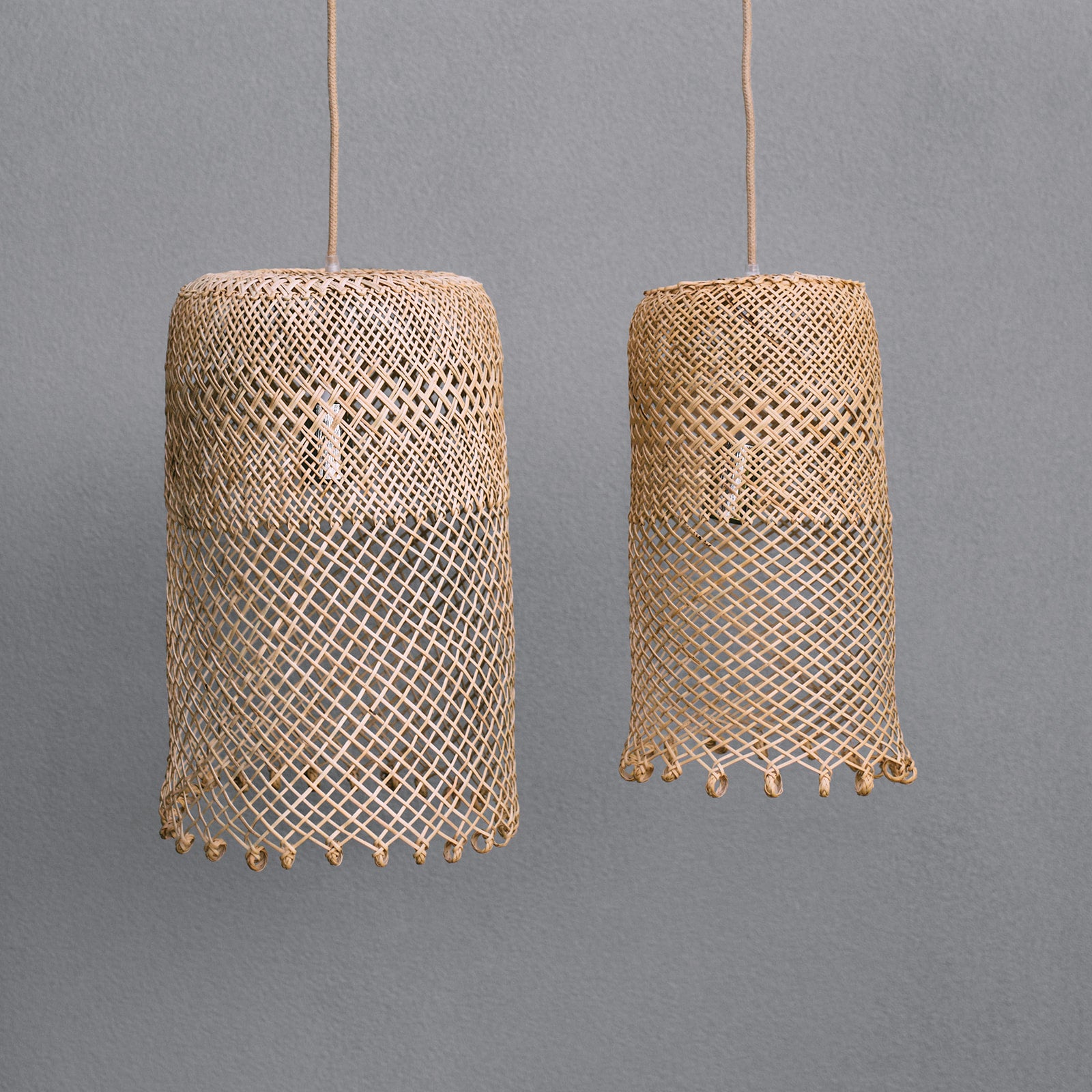 photo-of-Natural-coastal-boho-style-lighting-showing-a-small-and-a-medium-borneo-basket-light-shade-with-open-weave-and-ring-detail-at-the-bottom