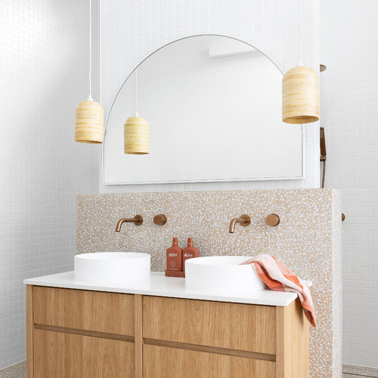 Scandi style light shades. Small bamboo light shades over a terrazzo tiled bathroom bench
